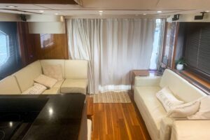 Stern view of 2016 Sunseeker Manhattan 65 motor yacht showing transom, swim platform, and teak cockpit seating in Boston.
