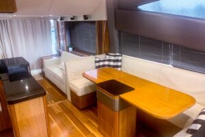 Sunseeker Manhattan 65 salon with cream upholstered seating, glass windows, and ambient lighting.