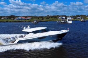 Tiara Yachts C44 Coupe helm station with dual Garmin displays and leather helm seating.
