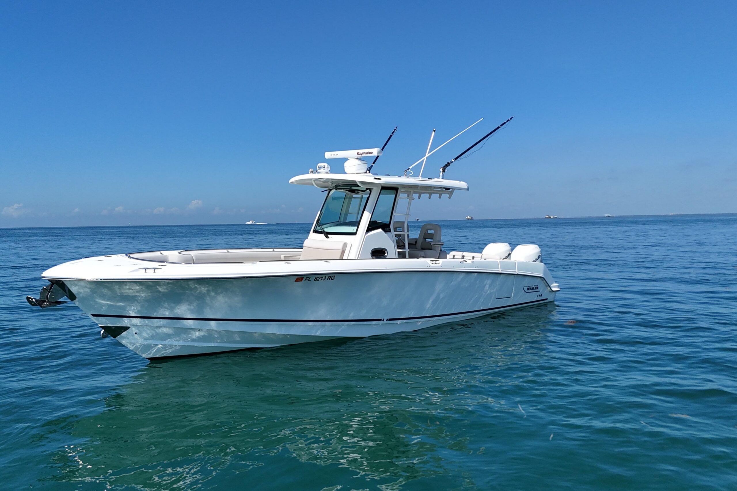 2017 Boston Whaler 330 Outrage center console fishing boat with twin outboard engines and hardtop, photographed from starb...