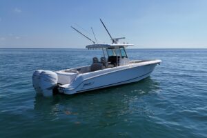 Bow seating and forward console of 2017 Boston Whaler 330 Outrage center console fishing boat with windshield and helm sta...