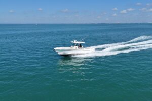 Bow seating and forward console of 2017 Boston Whaler 330 Outrage center console fishing boat with cushioned seating and w...