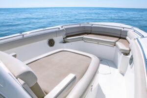 Helm station of 2017 Boston Whaler 330 Outrage with center console steering, dual Garmin displays, throttle controls, and ...