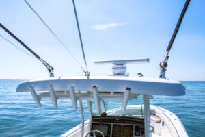 2017 Boston Whaler 330 Outrage center console helm station with dual Garmin displays, steering wheel, and throttle control...