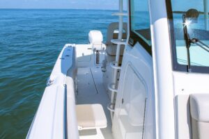 2017 Boston Whaler 330 Outrage center console helm station with dual Garmin displays, steering wheel, and throttle control...