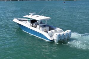 2017 HCB 42 Siesta hardtop helm station with dual Garmin displays, leather helm seat, and forward visibility over bow.