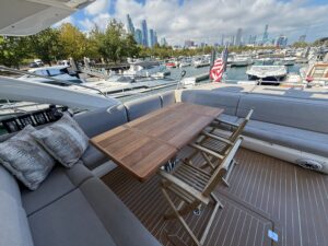 2017 Sunseeker Predator 68 salon with cream upholstered seating, teak accents, and panoramic windows overlooking the water.