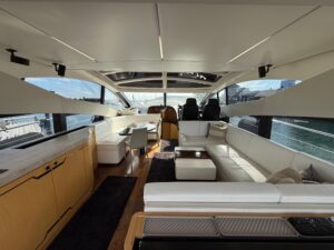 2017 Sunseeker Predator 68 helm station with dual Garmin displays, leather helm seating, and forward salon visibility thro...