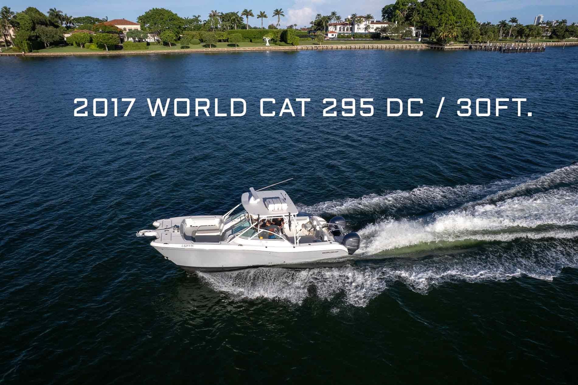 2017 World Cat 295 DC dual console catamaran with twin outboard engines shown in profile from starboard side.