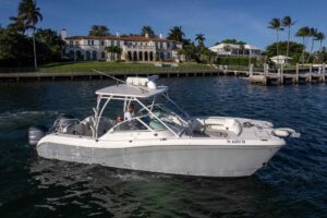 2017 World Cat 295 DC dual console catamaran helm station with Garmin electronics and steering wheel in Miami.