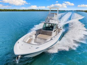 2020 Boston Whaler 380 Outrage 38-foot center console with twin outboard engines, hardtop, and full helm station viewed fr...