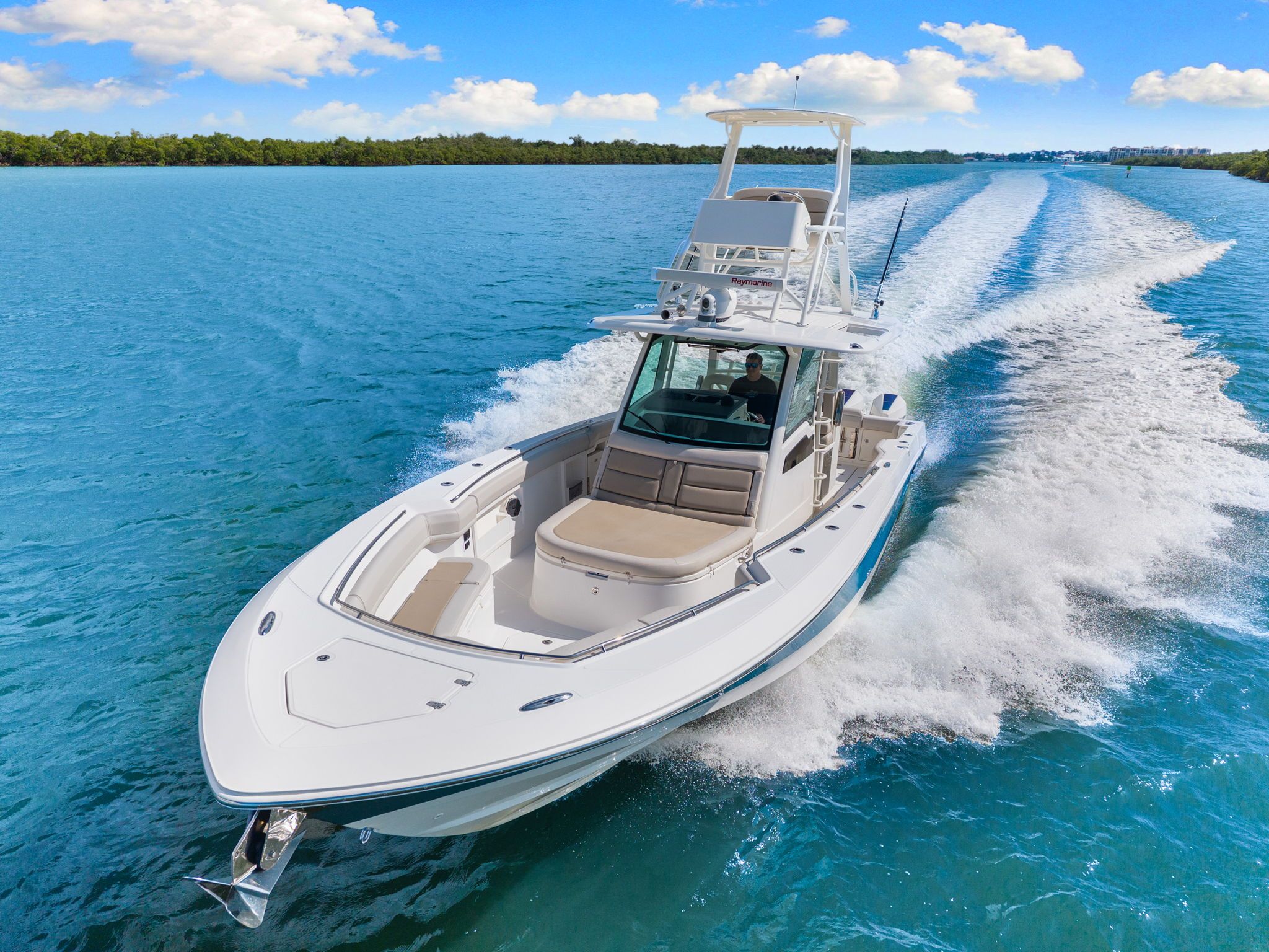 2020 Boston Whaler 380 Outrage 38-foot center console with twin outboard engines, hardtop, and full helm station viewed fr...