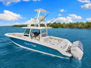 Helm station of 2020 Boston Whaler 380 Outrage with dual Garmin displays, center console steering, and forward visibility ...