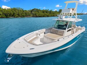Boston Whaler 380 Outrage center console helm with dual Garmin displays, steering wheel, and forward visibility toward bow...