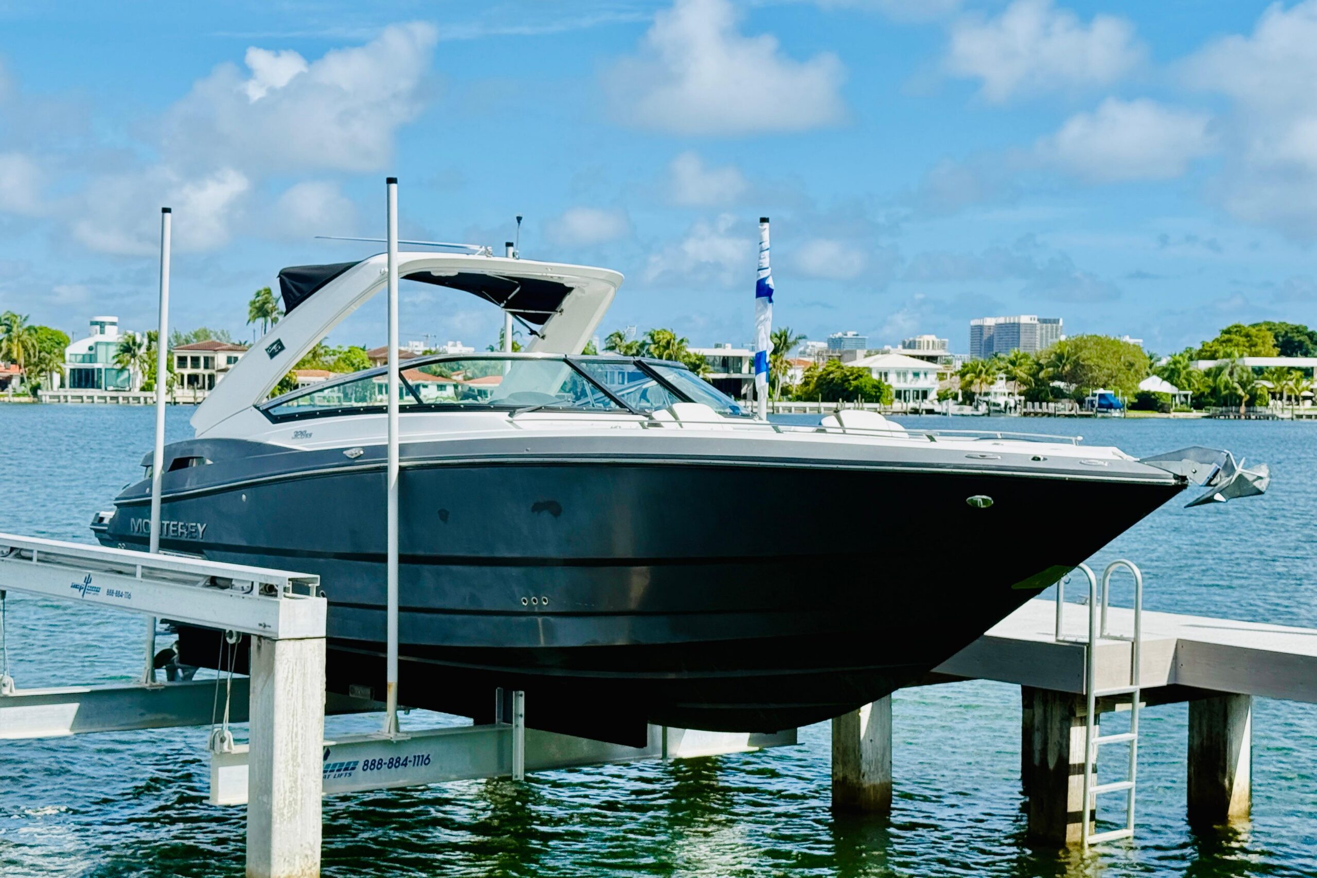 2020 Monterey 328SS Super Sport 33-foot center console with twin outboard engines, bow seating, and hardtop, moored in Mia...