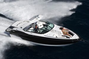 Helm station of 2020 Monterey 328SS Super Sport with dual Garmin displays, steering wheel, and center console controls ove...
