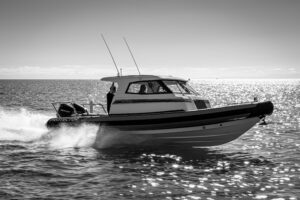 2020 Protector 310 Targa 30-foot center console with hardtop and outboard engines shown in profile starboard view.