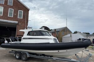 2020 Protector 310 Targa hardtop helm station with dual Garmin displays and center console steering.