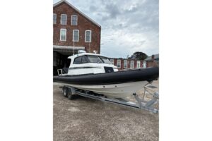 Protector 310 Targa helm station with dual Garmin displays, steering wheel, and center console controls.