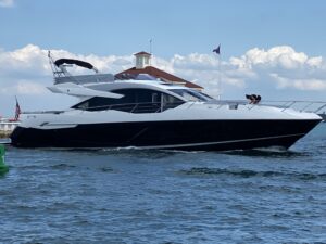 Sunseeker 74 Sport Yacht bow seating area with forward cabin access and curved windscreen.