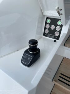 Sunseeker 74 Sport Yacht helm station with dual Garmin multifunction displays, leather helm seat, and forward cabin visibi...