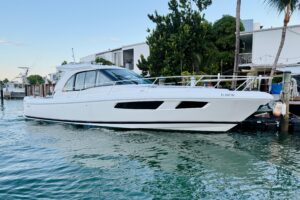 2021 Intrepid 410 Evolution 41-foot center console yacht profile with twin outboard engines and hardtop tower in Miami Beach.