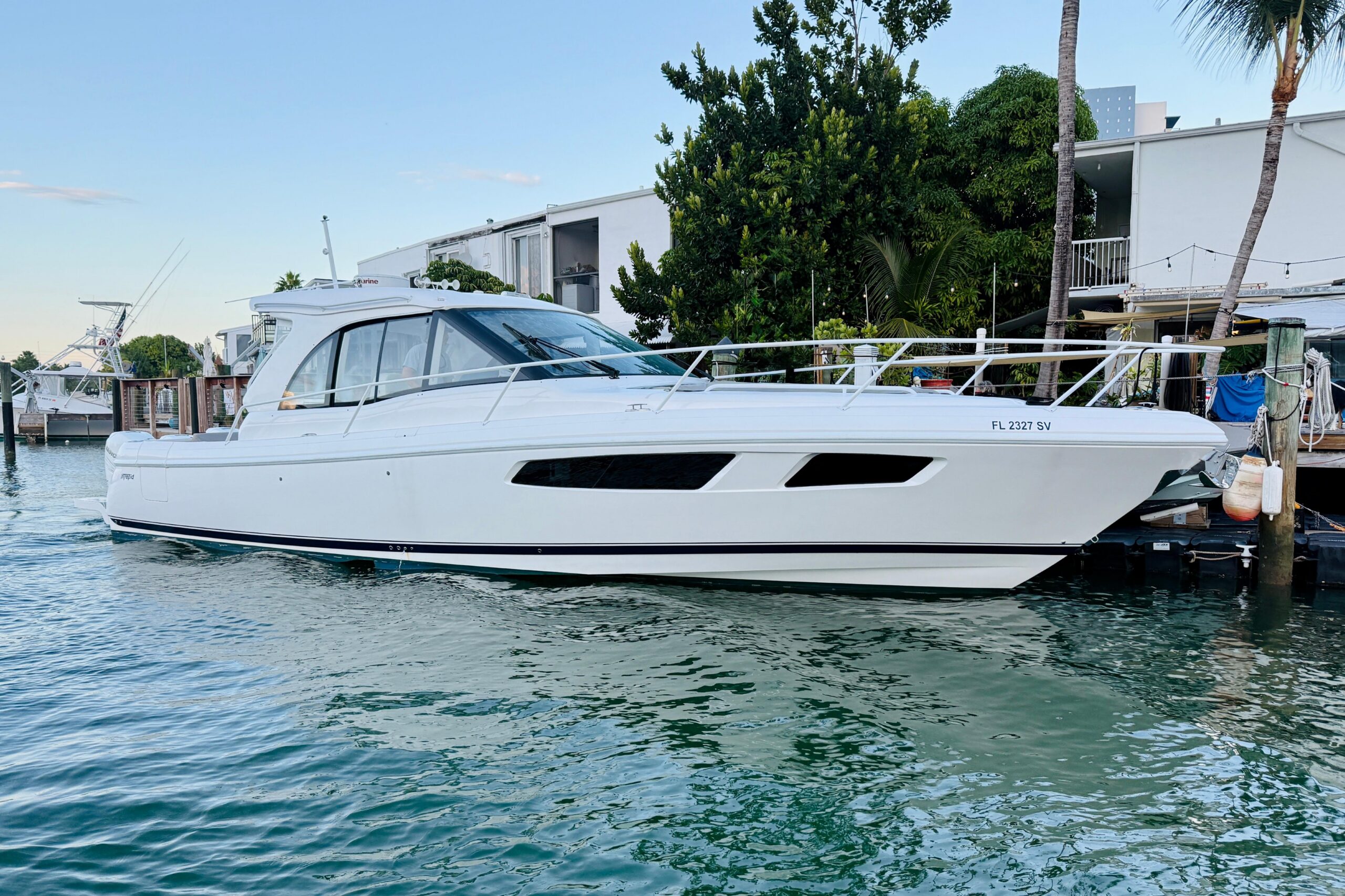 2021 Intrepid 410 Evolution 41-foot center console yacht profile with twin outboard engines and hardtop tower in Miami Beach.