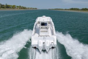 Bow seating and forward console area of 2021 Sportsman Open 322 center console with cushioned seating and integrated storage.