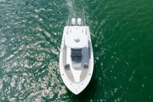Sportsman Open 322 center console helm station with dual Garmin displays, steering wheel, and throttle controls.