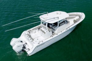 Sportsman Open 322 center console helm station with dual Garmin displays, steering wheel, and throttle controls.