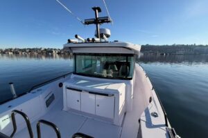Axopar 37 XC Cross Cabin bow seating area with forward cabin access and integrated helm visibility from elevated vantage p...