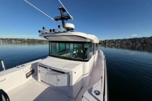 Axopar 37 XC Cross Cabin helm station with dual Garmin displays, leather helm chair, and forward visibility through windsc...