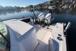 Axopar 37 XC Cross Cabin helm station with dual Garmin displays, center console steering, and forward visibility through h...