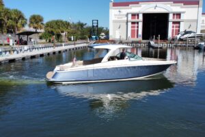2022 Chris-Craft Launch 35 GT with inboard-outboard engines showing bow seating and forward cabin entry.