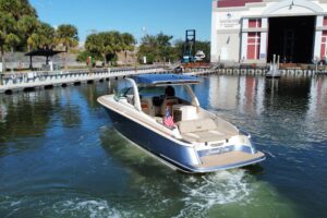 2022 Chris-Craft Launch 35 GT center console helm with dual Garmin displays, steering wheel, and helm seating overlooking ...