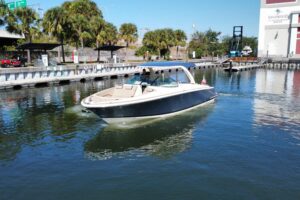 Chris-Craft Launch 35 GT helm station with dual Garmin displays, steering wheel, and throttle controls overlooking the win...