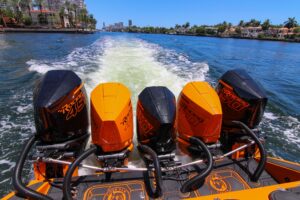 Midnight Express 43 Open center console helm station with dual Garmin displays, steering wheel, and throttle controls in M...