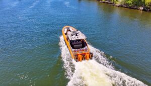 Midnight Express 43 Open center console helm with dual Garmin displays, steering wheel, and throttle controls overlooking ...