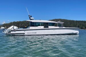 Axopar 37 XC Cross Cabin bow seating area with forward cabin entry and windshield viewed from starboard side.