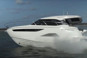 2023 Bavaria R40 Coupe cabin interior with upholstered seating, overhead lighting, and cabin berth visible through doorway.