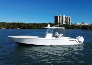 Contender 32 ST center console helm with dual Garmin displays, steering wheel, and throttle controls overlooking the winds...