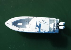 Contender 32 ST center console helm station with dual Garmin displays, steering wheel, and throttle controls overlooking t...