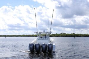Contender 44 ST center console boat with hardtop and outriggers viewed from starboard bow angle in Stuart Florida waters.