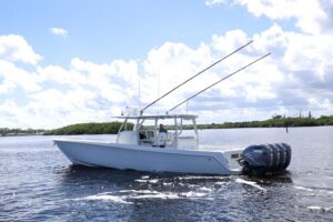 Contender 44 ST center console helm station with dual Garmin displays, leather helm seat, and hardtop overhead.