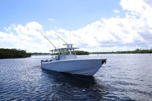 Contender 44 ST center console helm station with dual Garmin displays, leather seating, and hardtop overhead.