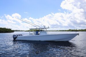 Contender 44 ST center console helm station with dual Garmin displays, stainless steel wheel, and forward windscreen visib...