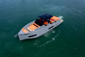 2023 De Antonio Yachts D50 center console helm station with dual Garmin displays and steering wheel in Miami.