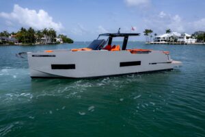 2023 De Antonio Yachts D50 helm station with dual Garmin displays, leather seating, and center console steering in Miami.
