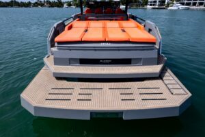 2023 De Antonio Yachts D50 center console helm station with dual Garmin displays and stainless steel steering wheel.