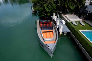 2023 De Antonio Yachts D50 cabin cruiser helm station with dual helm seats, steering wheel, and integrated Garmin electron...